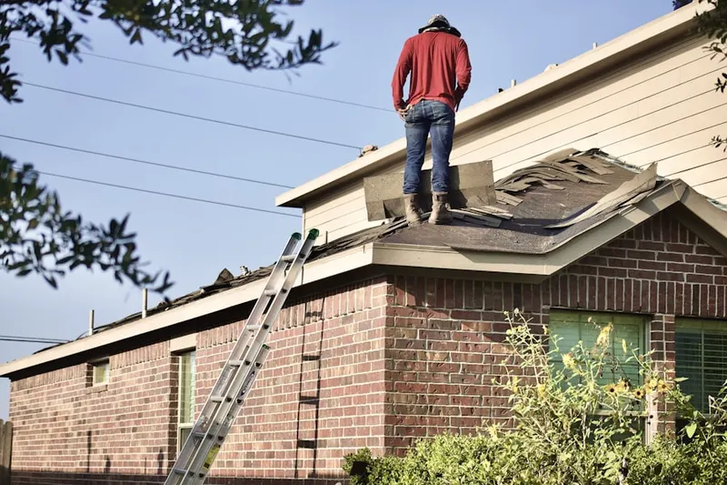 Professional roofer working on a residential roof in Takoma Park
